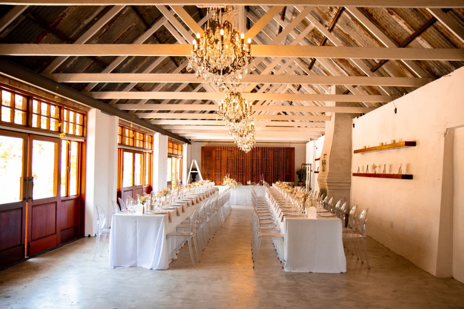 Crystal chandeliers above a set reception room