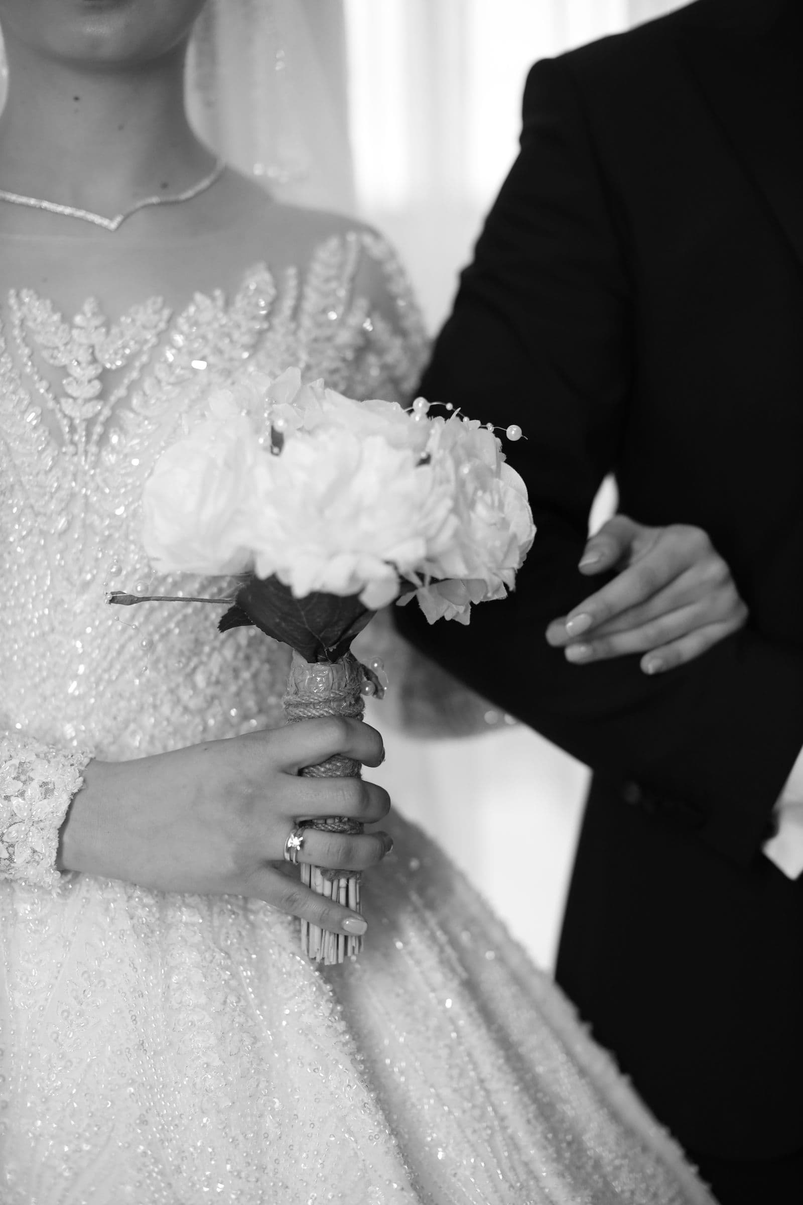 A close study of the bride's hands and her bouquet
